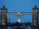 Full Moon behind Olympic Rings beneath Tower Bridge in London UK